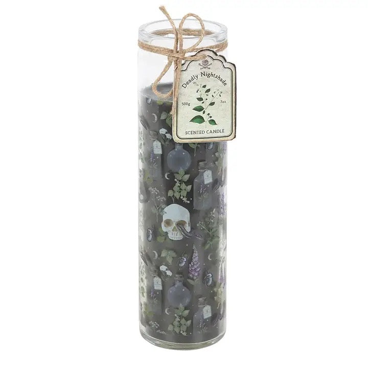 A tall clear glass jar candle tied with twine and a decorative tag that reads 'Candy Nightmares' and 'Scented Candle.' The candle wax inside is very dark, nearly black, with printed Halloween-themed illustrations including skulls, tombstones, and small purple flowers.