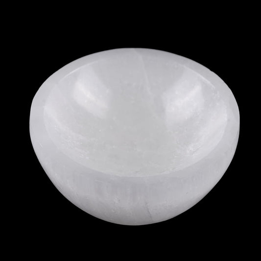 White selenite bowl on a black background