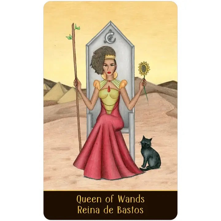 Tarot card featuring a woman in a red dress holding a flower and a staff, with text 'Queen of Wands Reina de Bastos' on a desert background.