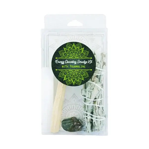 Energy cleansing smudge kit with sticks, wooden tool, and stones in packaging on a white background