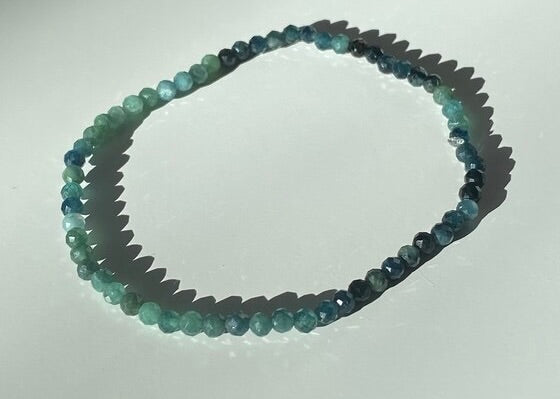 Beaded necklace with multicolor stones on a white background