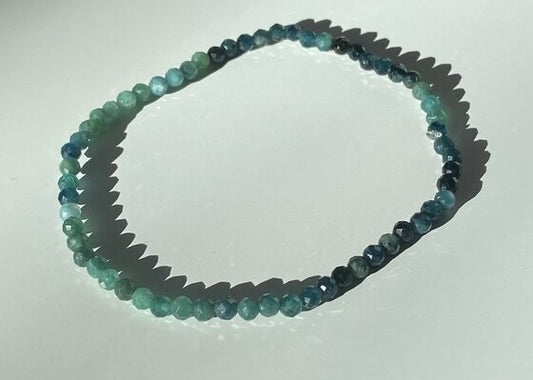 Beaded necklace with multicolor stones on a white background