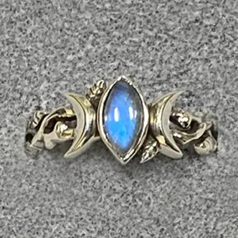 Silver ring with a blue gemstone on a gray background