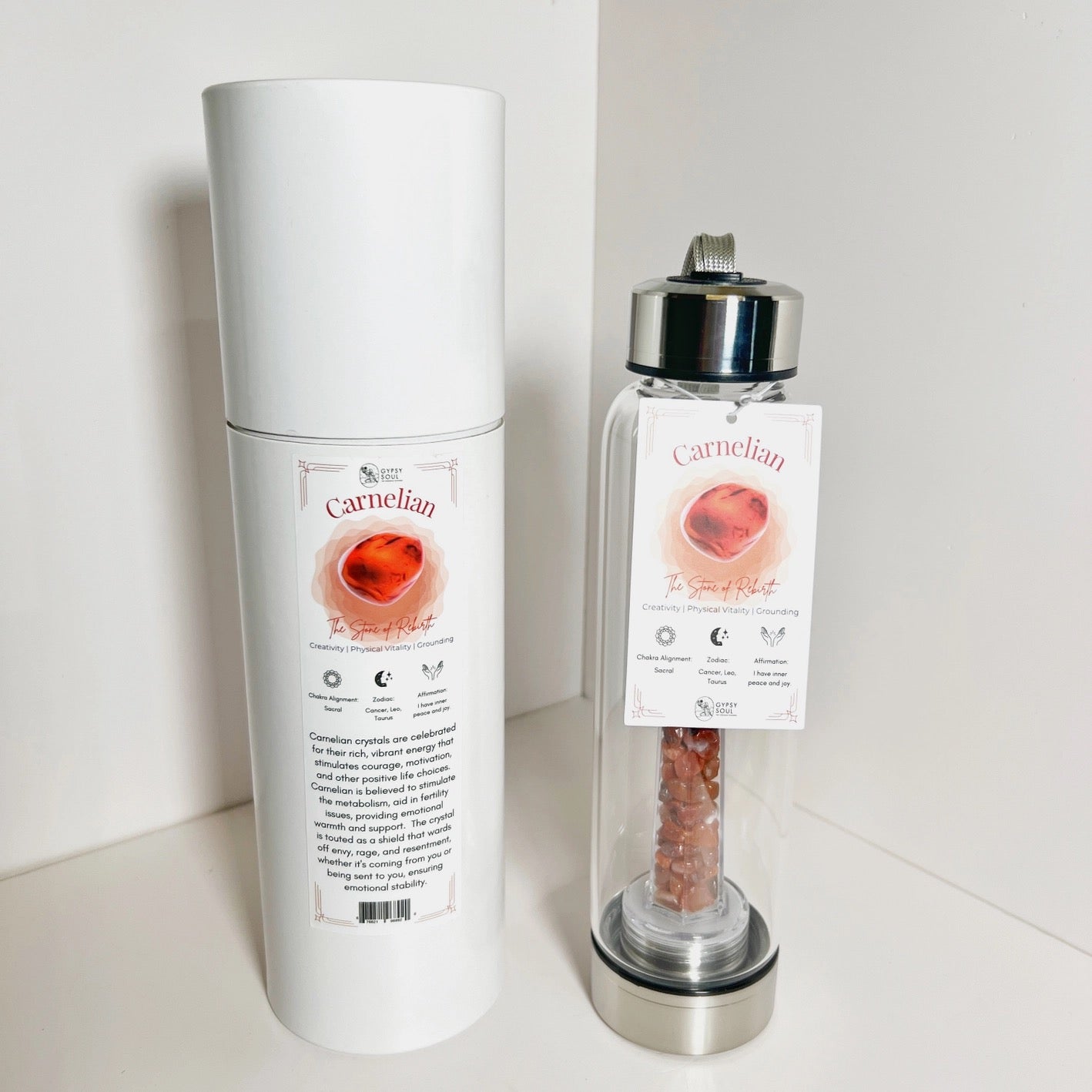 White cylindrical container and glass bottle with Carnelian stone on a white background