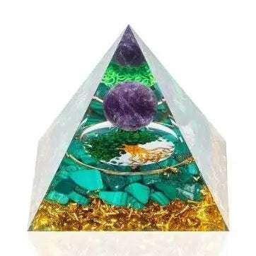 Pyramid-shaped crystal with purple sphere, green stones, and gold elements on a white background