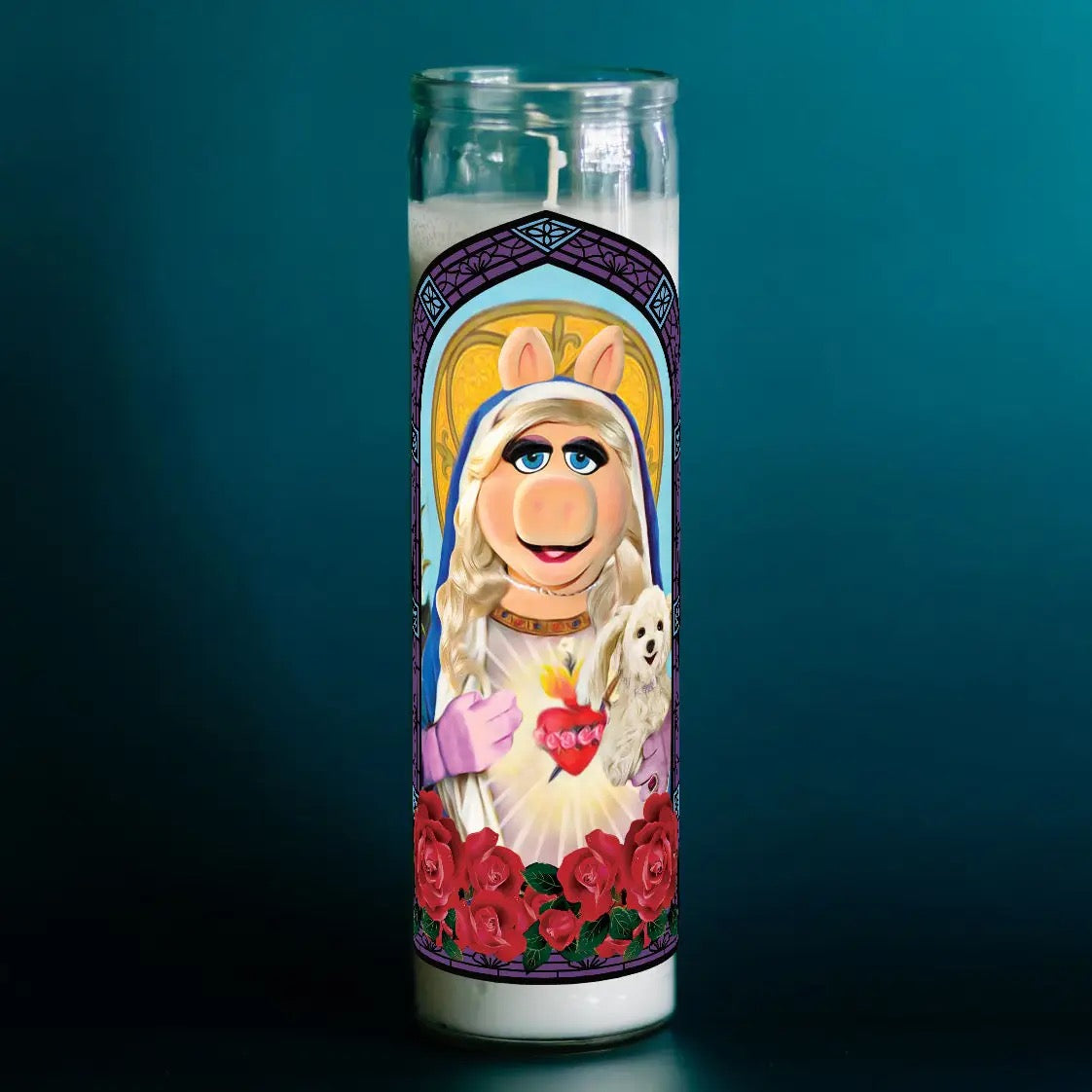Decorative candle with a character design on a dark background