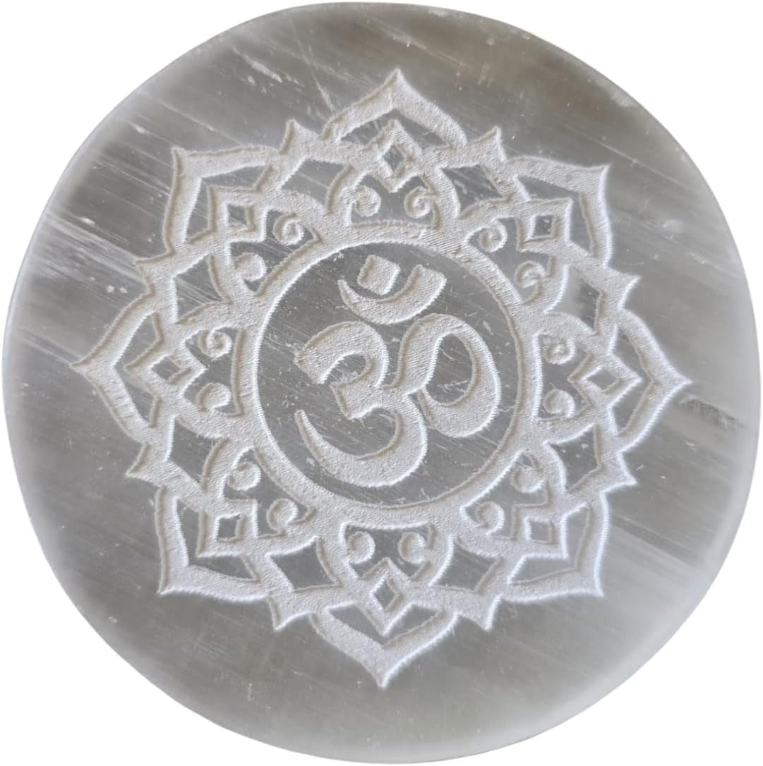 Crystal stone with engraved 'Om' symbol on a white background