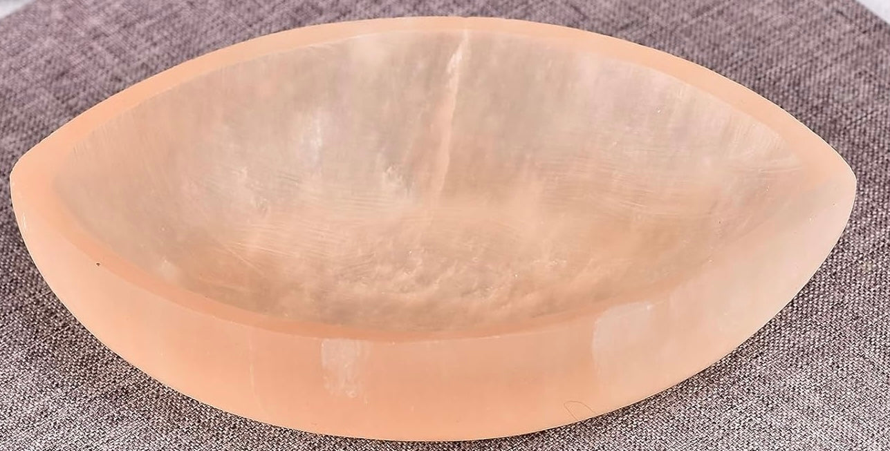 Orange Selenite bowl on a textured gray background