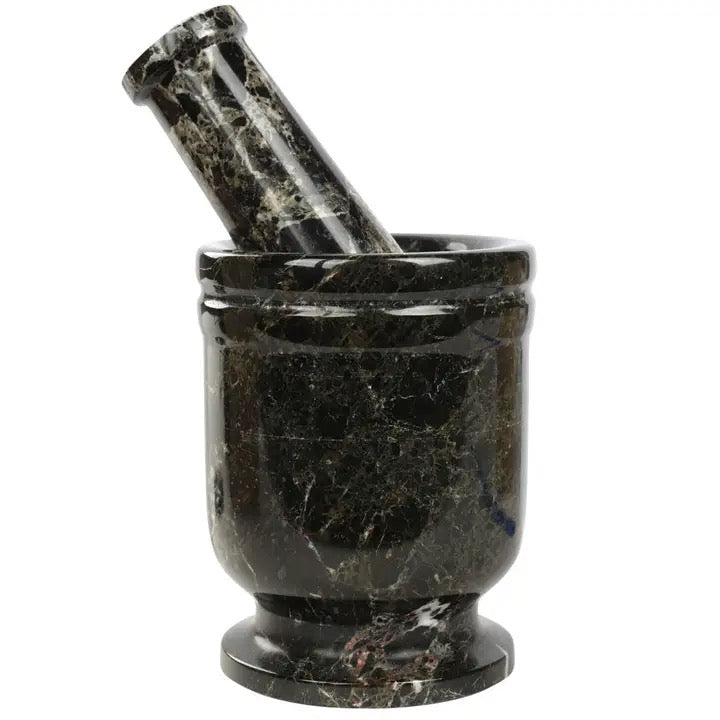 Black marble mortar and pestle on a white background
