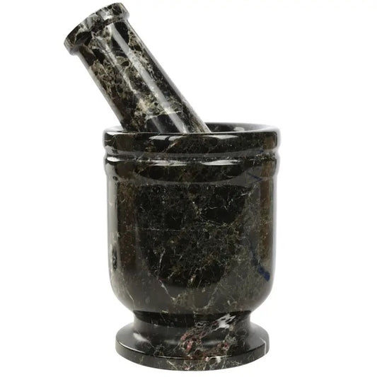 Black marble mortar and pestle on a white background