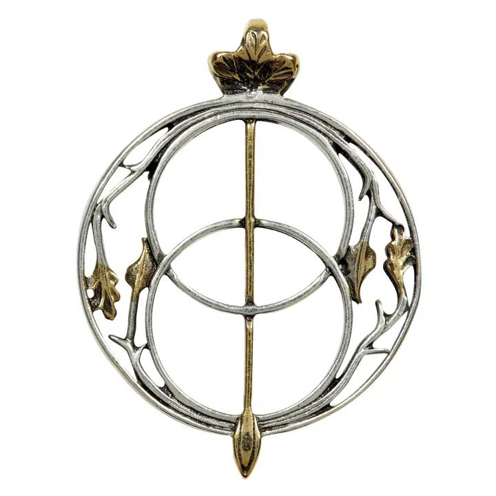 Decorative brooch with circular design and gold accents on a white background