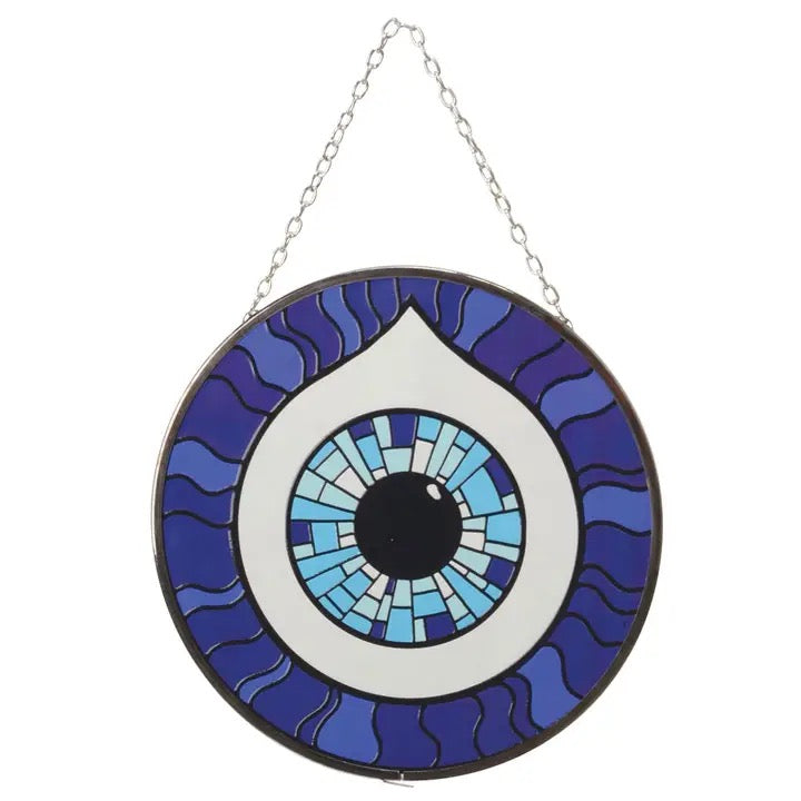 Decorative glass panel with eye design on a white background