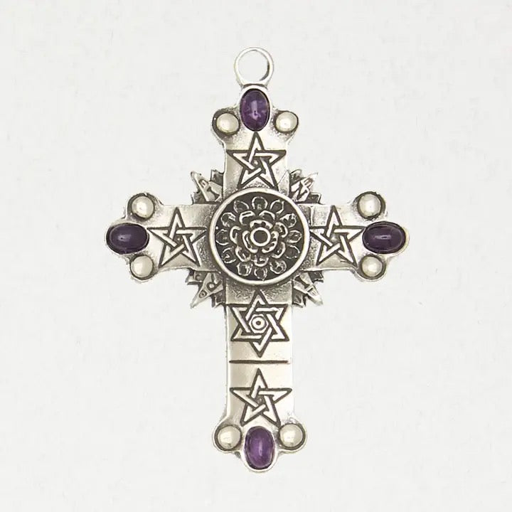 Silver cross pendant with star designs and purple gemstones on a white background
