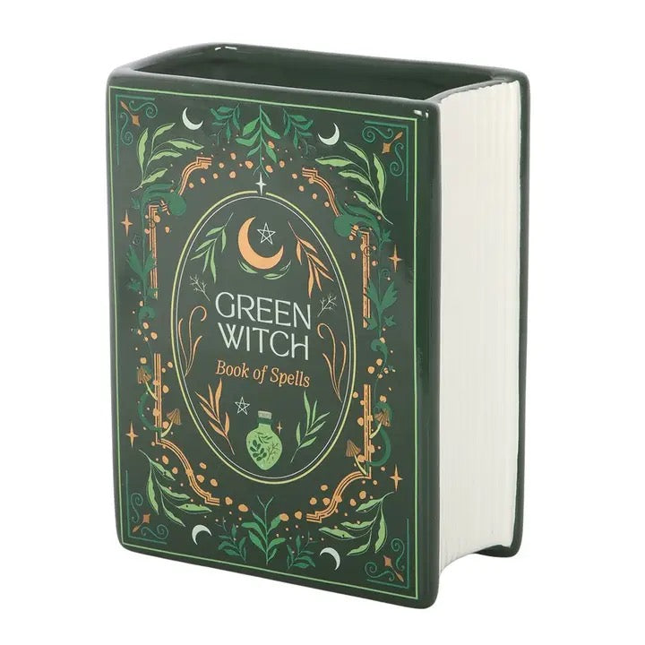 Decorative book titled 'Green Witch Book of Spells' with green and gold design on a white background