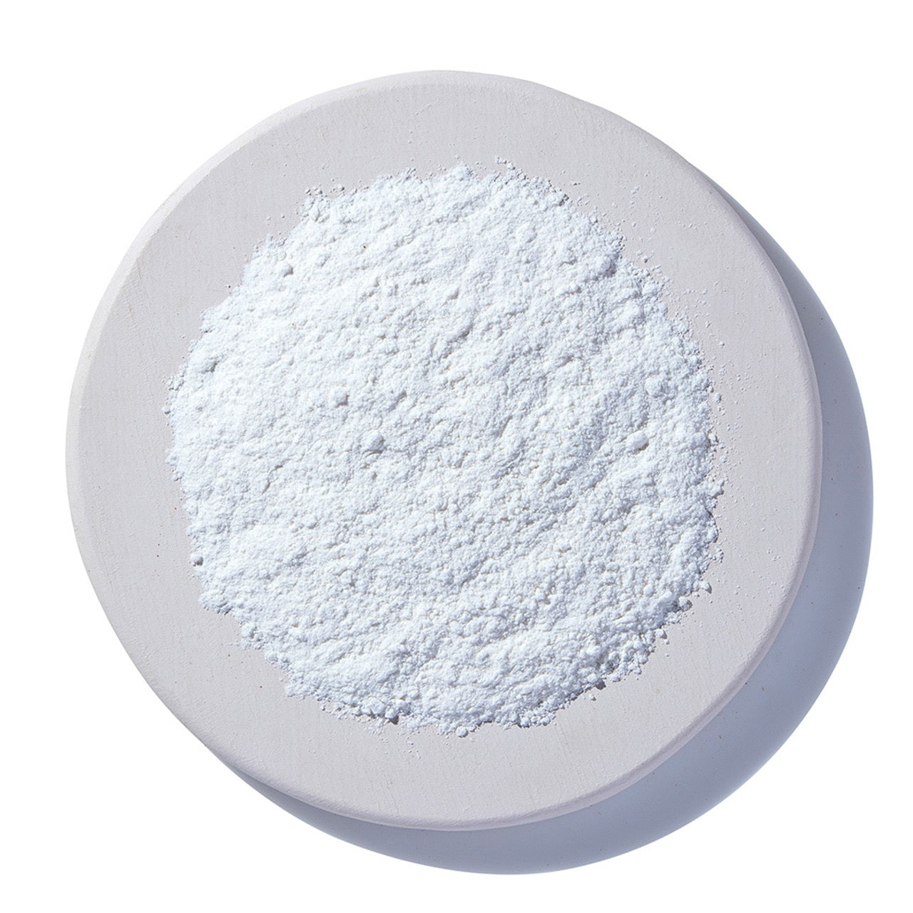 White powder on a white plate with a white background