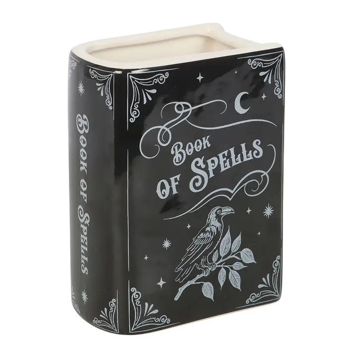 Black container with 'Book of Spells' design featuring a raven on a white background