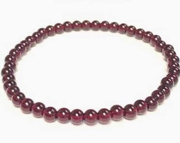 Beaded bracelet with purple beads on a white background