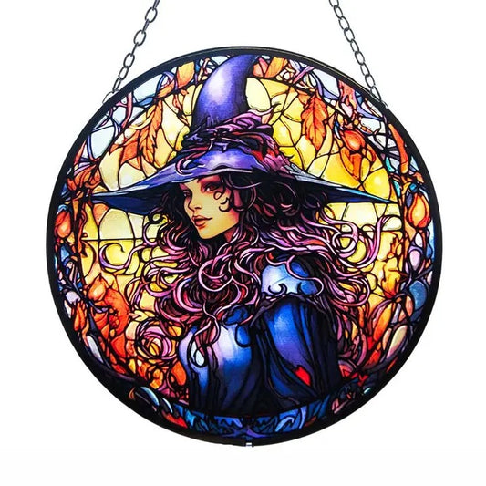 Stained glass window hanging with a witch design on a white background