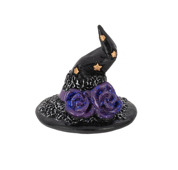 A small black witch hat figurine with purple glittery roses at the base and small gold stars, shown on a plain white background.