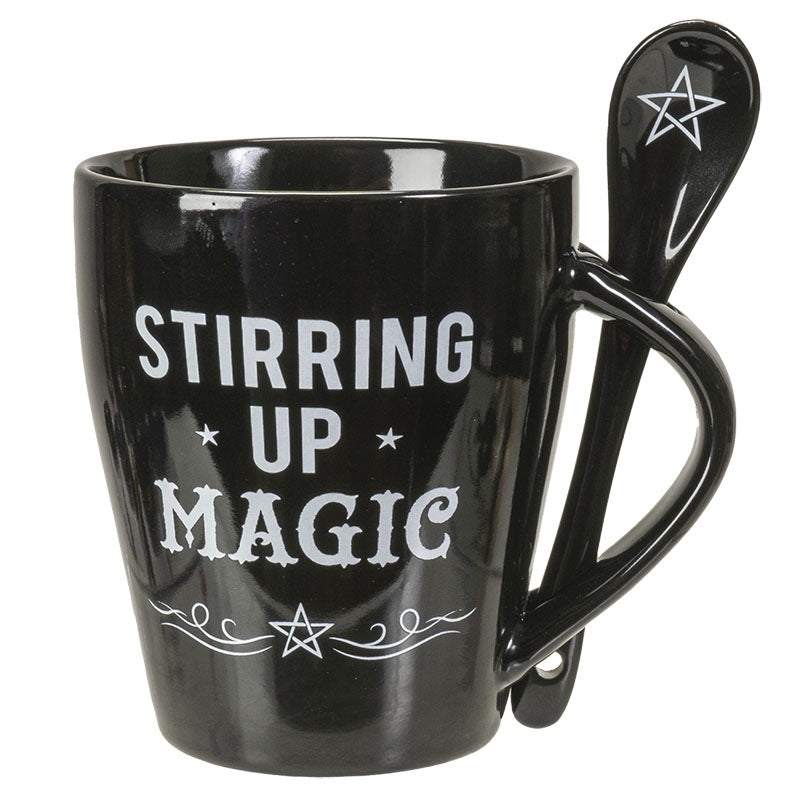 Black mug with 'Stirring Up Magic' text and a spoon featuring a star design on a white background