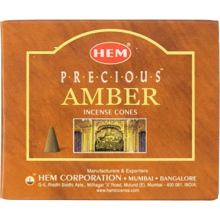 Box of HEM Precious Amber incense cones with branding and product details.