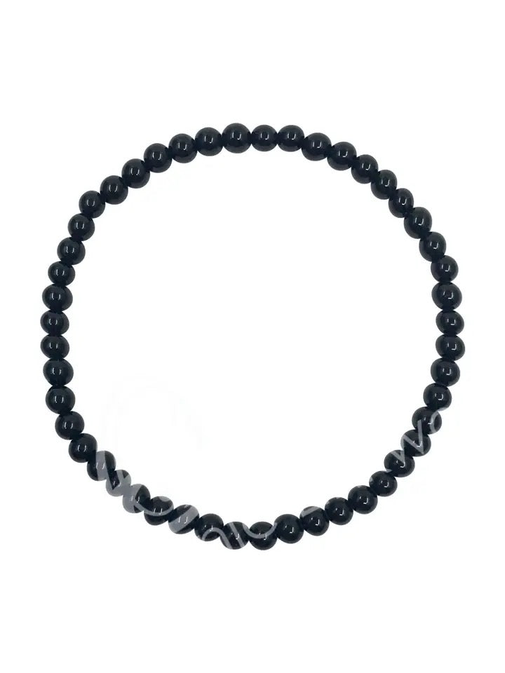 Black beaded bracelet on a white background