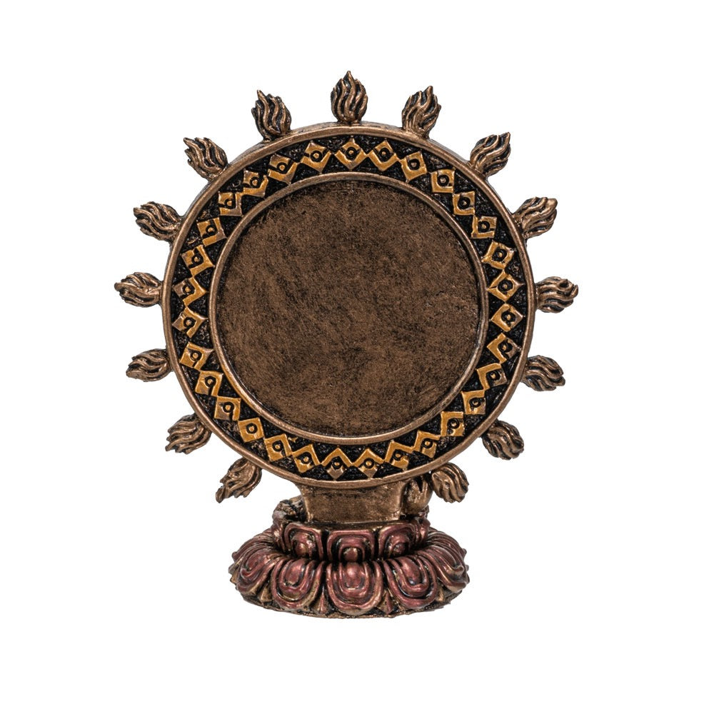 Decorative bronze wheel with intricate patterns on a white background