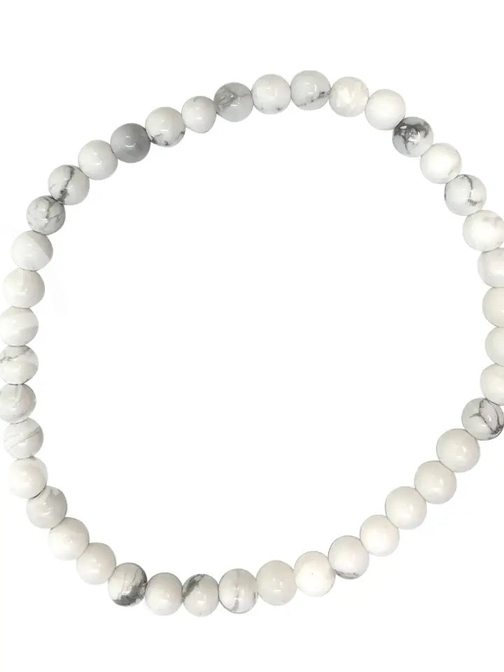 White beaded bracelet on a white background