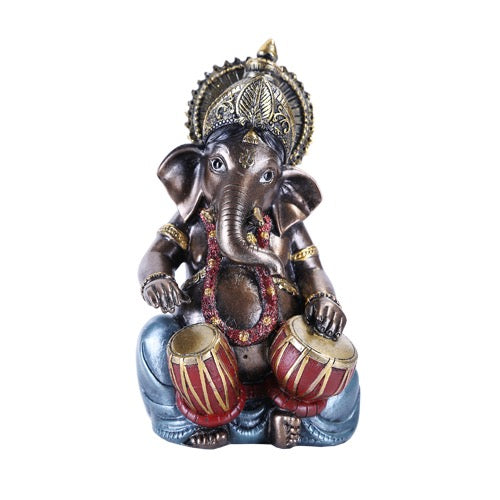Decorative statue of an elephant with a headdress and drums on a white background