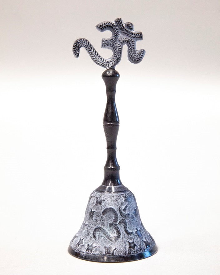 Decorative bell with intricate design and symbol on a white background