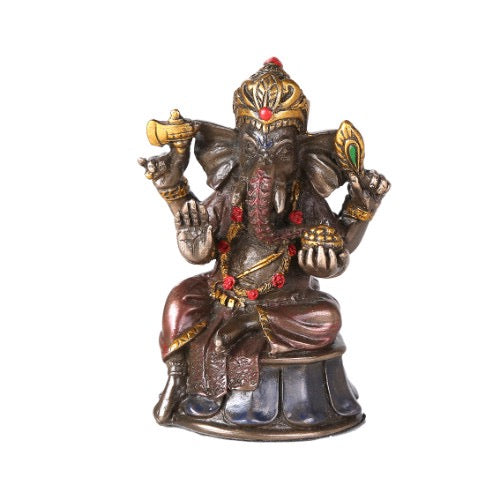 Decorative statue of a seated deity with intricate details on a white background