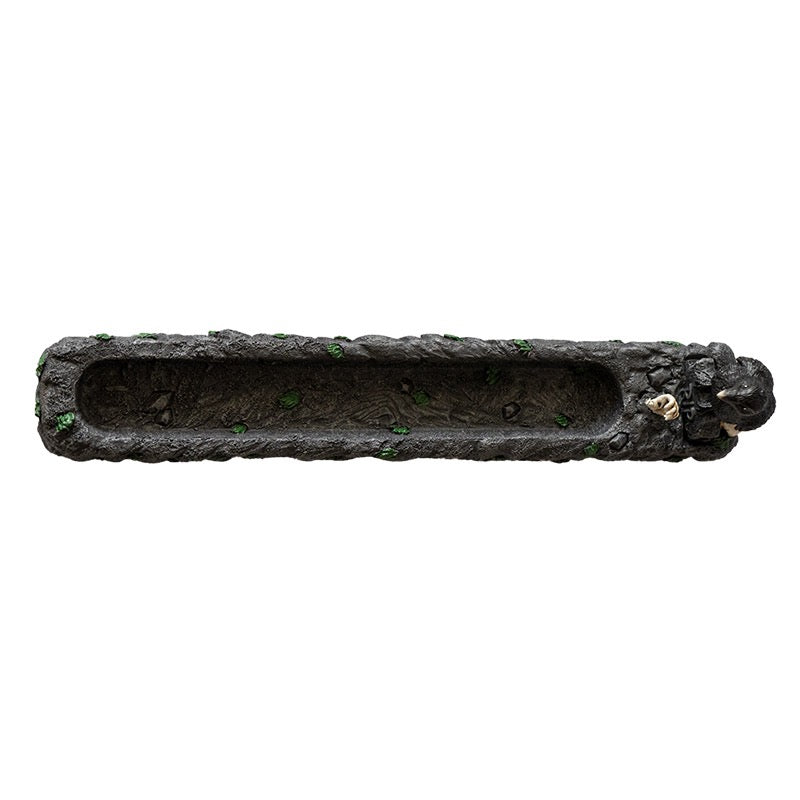 A incense burner, crow, and an incense  stick on a white background top down view