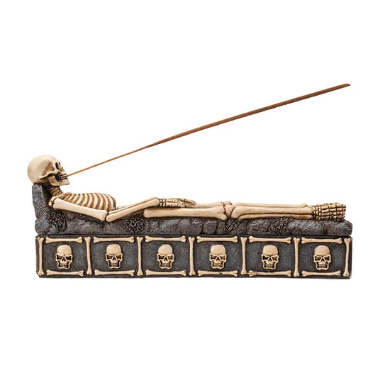 Incense burner with skeleton design and skull patterns on a white background