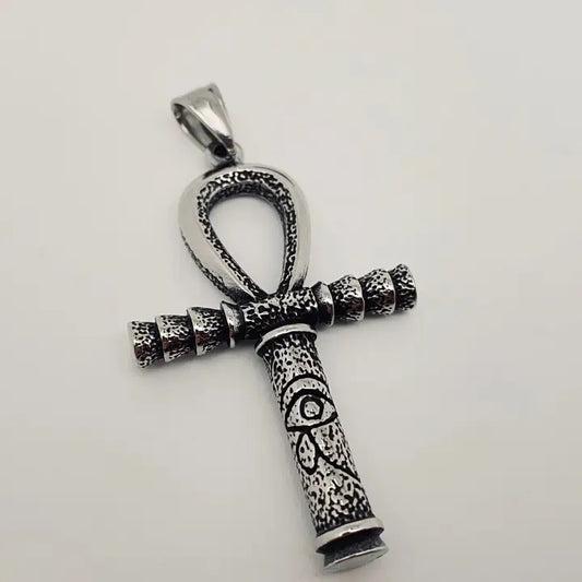 Silver ankh pendant on a light gray background