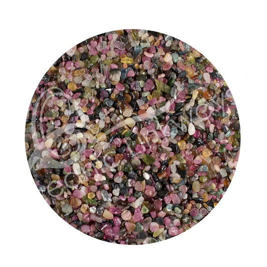 Round container filled with multicolored gemstones on a white background