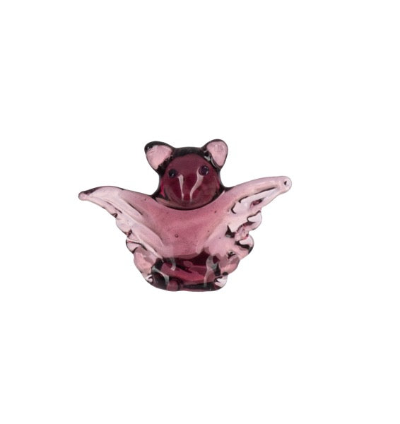A small translucent pink and dark purple glass figurine shaped like a mouse with wings, shown on a plain white background.