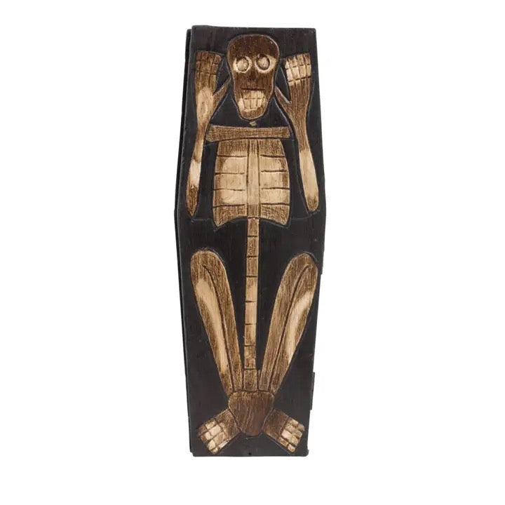 A dark wooden skeleton figurine with detailed burnished wood textures on its bones, shown against a plain white background.
