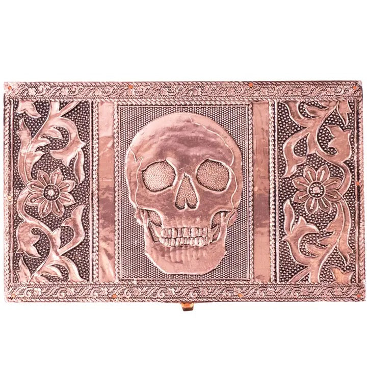 Copper box with skull design and floral patterns on a white background