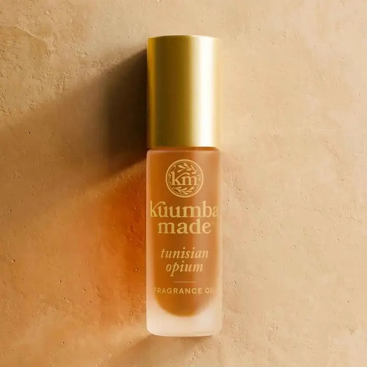 Kuumba Made Tunisian Opium fragrance oil bottle on a beige background