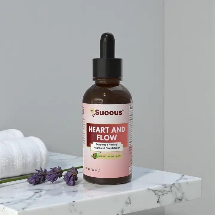 Bottle of Succus Heart and Flow supplement on a marble surface with lavender flowers.