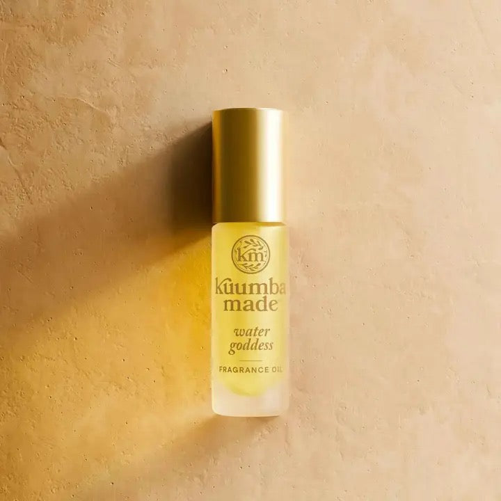 Fragrance oil bottle labeled 'kumba made' on a beige background