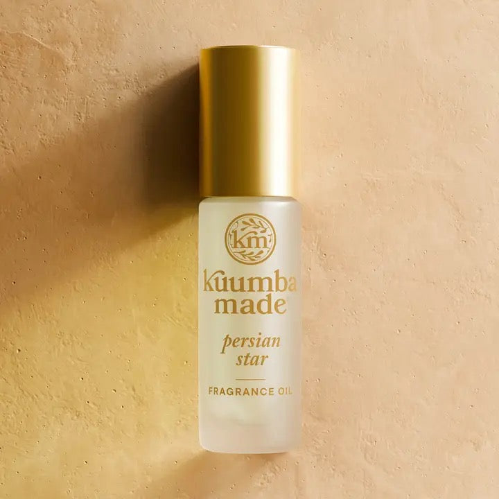 Kuumba Made Persian Star fragrance oil bottle on a beige background