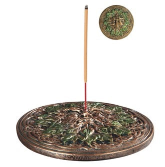Decorative incense burner with a lit incense stick on a white background