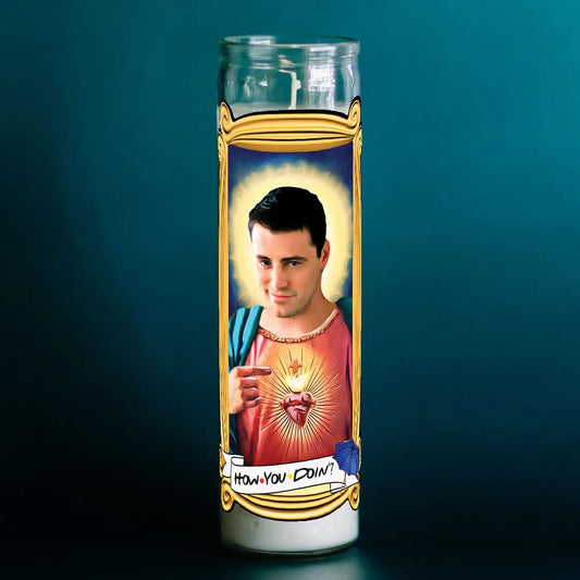 Candle with a printed design of a person and text on a dark background