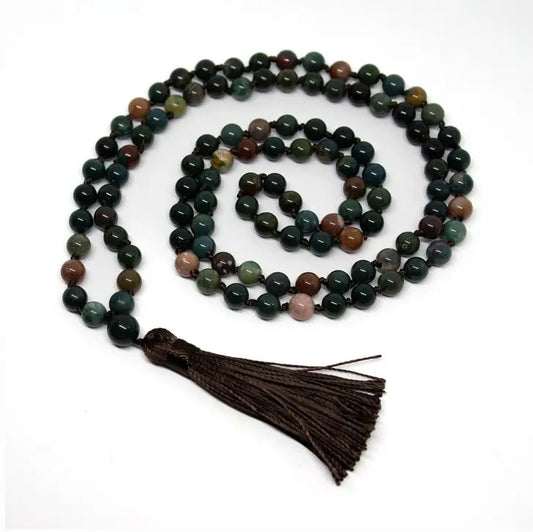Necklace with multicolored beads and a tassel on a white background