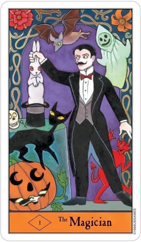 A tarot card titled 'The Magician' featuring a whimsical illustration of a magician in a black tuxedo holding up a white rabbit in a hat, surrounded by a black cat, a green ghost, a red devil, a jack-o'-lantern, and a bat against a purple and blue patterned background.