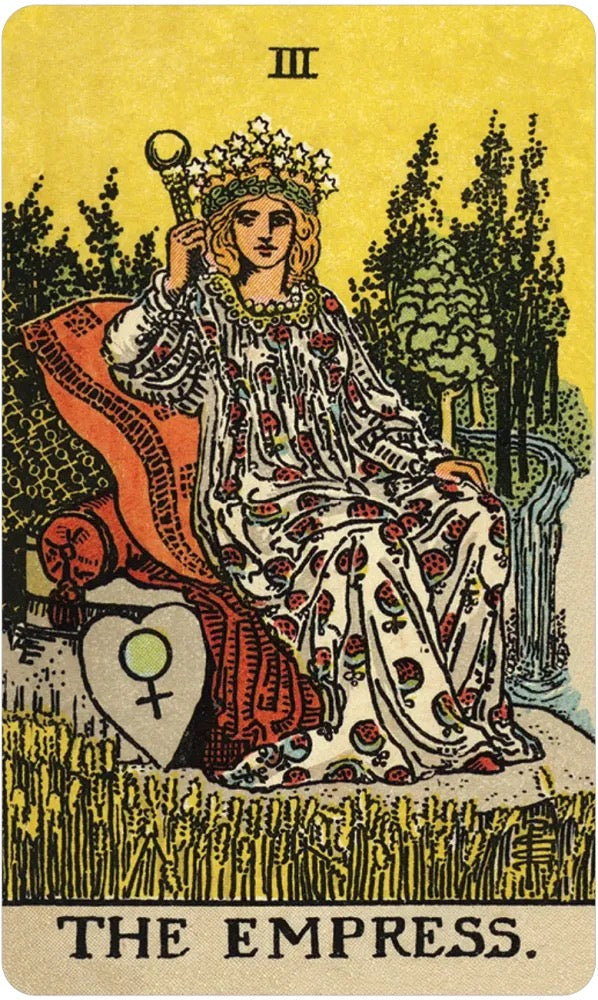 The Empress tarot card featuring an illustration of a crowned queen in a patterned gown seated on a throne, with trees, grass, and a heart-shaped shield on a yellow background. The Roman numeral III appears at the top, and 'THE EMPRESS.