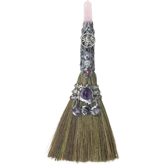Decorative broom with crystal handle on a white background