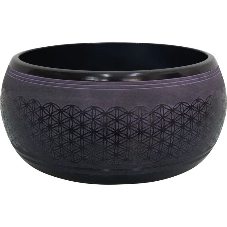 Black singing bowl side view on a white background