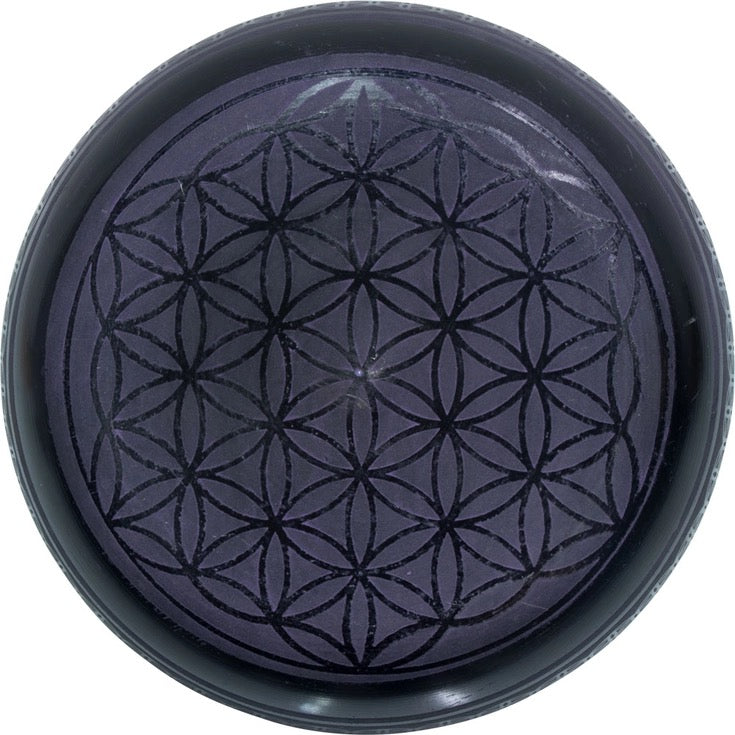 Black singing bowl bottom view on a white background
